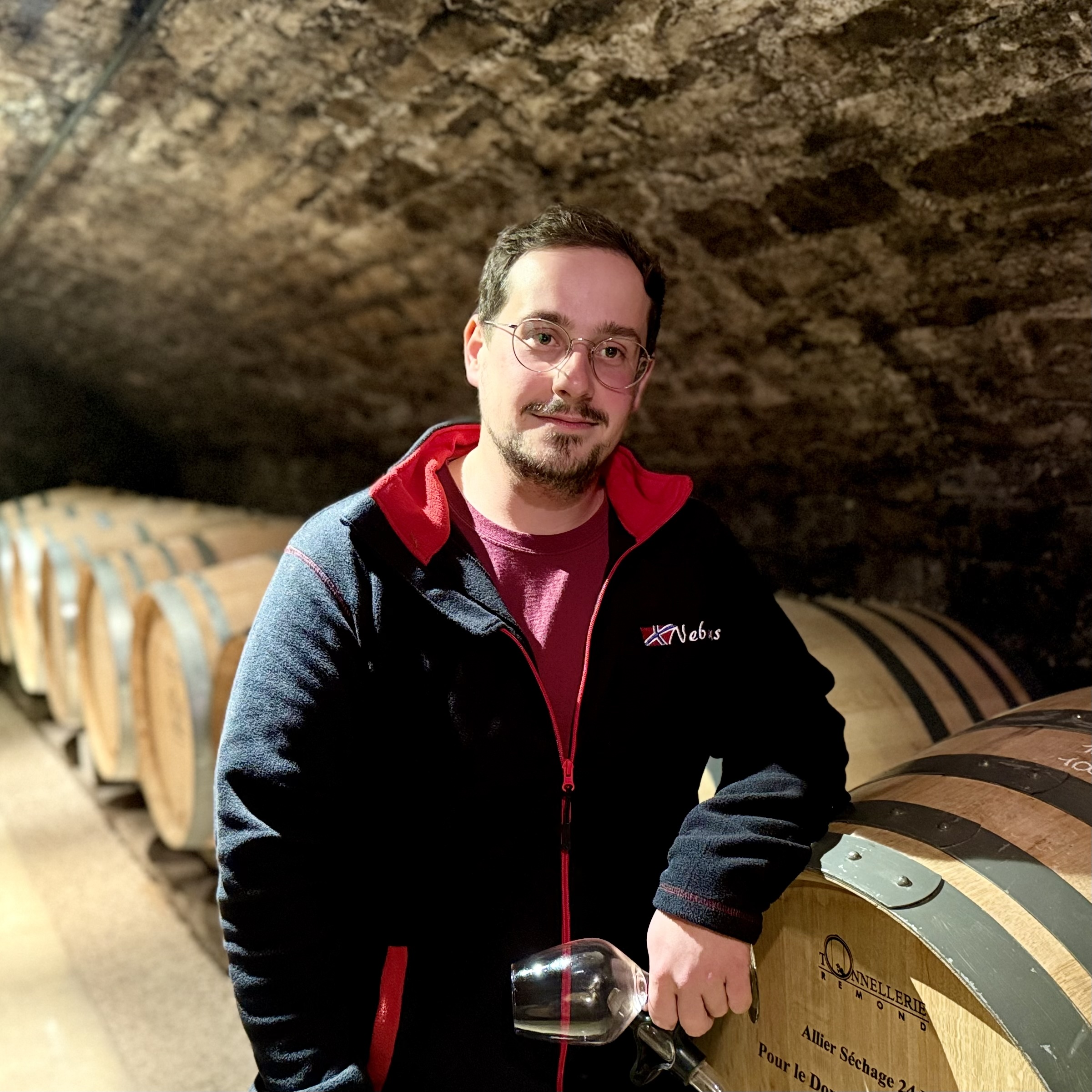 Louis Essa standing beside a stone wall
