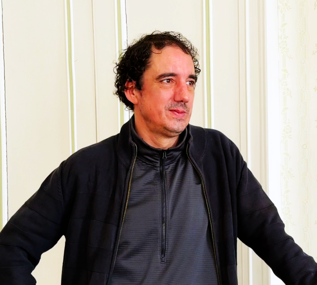 Louis Vallet standing indoors